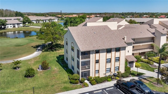 drone / aerial view with a water view and a residential view