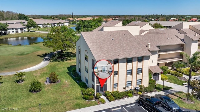 drone / aerial view with a water view and a residential view