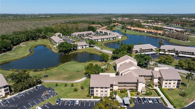 drone / aerial view featuring a residential view, a water view, and view of golf course