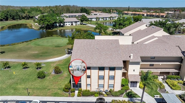 bird's eye view featuring golf course view and a water view