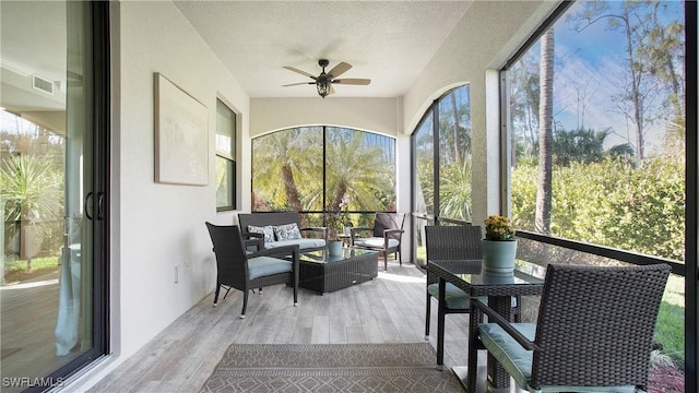 sunroom / solarium featuring a ceiling fan and visible vents