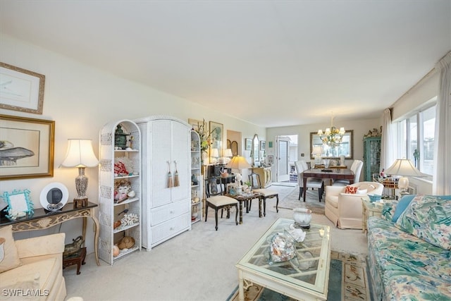 living room with a chandelier and carpet floors