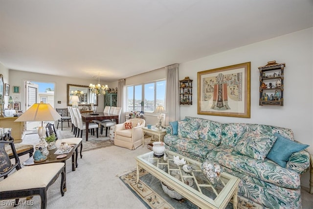 living area featuring an inviting chandelier and carpet