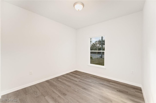 empty room with wood finished floors and baseboards