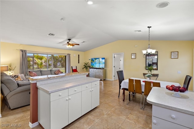 kitchen with visible vents, a kitchen island, open floor plan, light countertops, and lofted ceiling