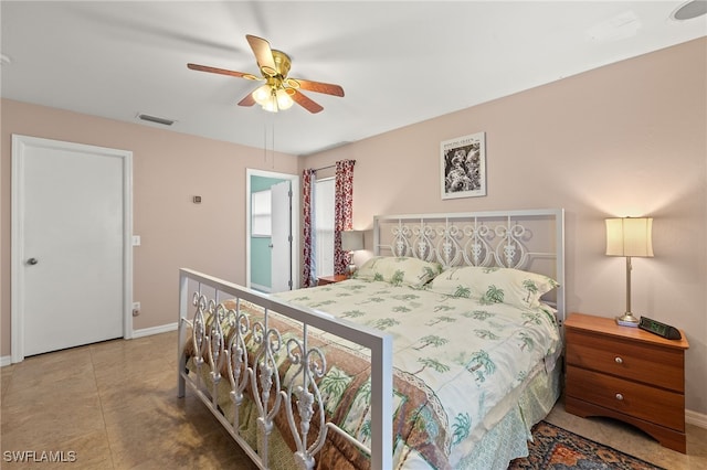 tiled bedroom with visible vents, ceiling fan, and baseboards