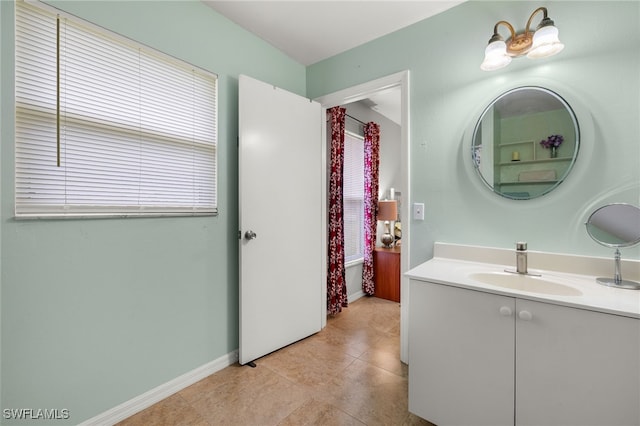 bathroom featuring vanity, tile patterned floors, and baseboards