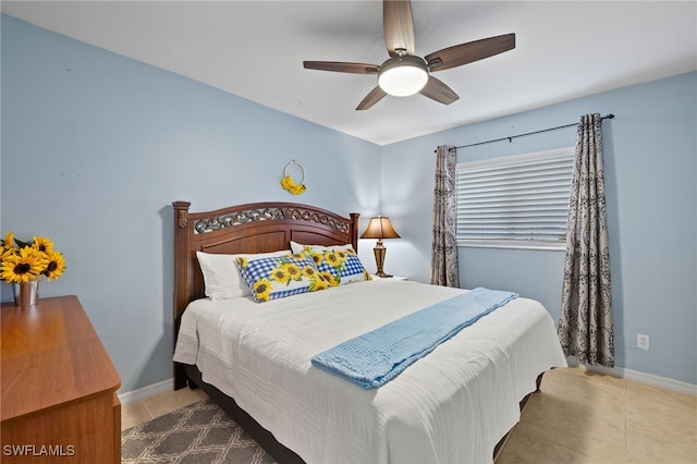 bedroom with tile patterned flooring, ceiling fan, and baseboards