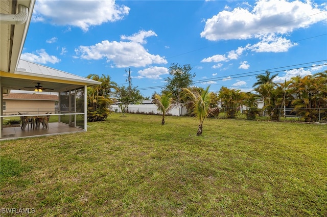 view of yard featuring a patio, a fenced backyard, and a sunroom