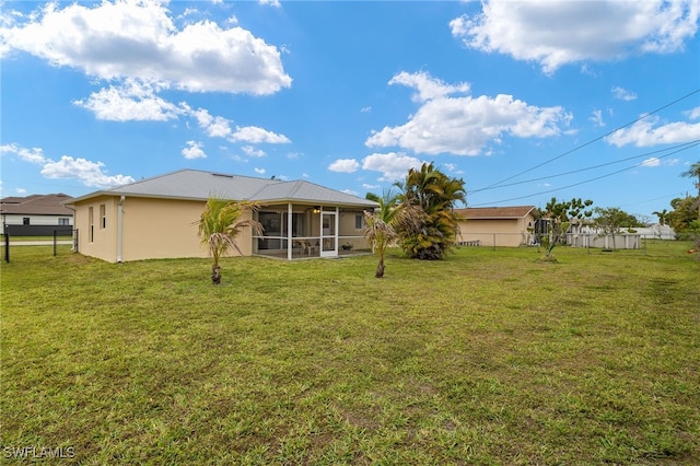 view of yard with fence and a sunroom