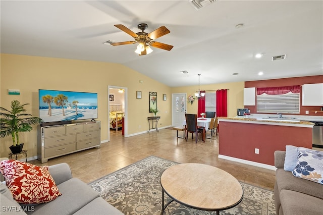 living room with light tile patterned flooring, visible vents, and vaulted ceiling