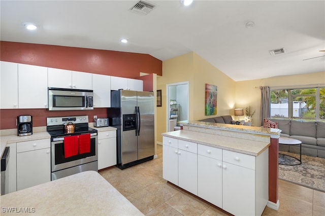 kitchen featuring light countertops, visible vents, open floor plan, and stainless steel appliances