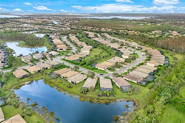 drone / aerial view featuring a water view and a residential view