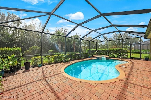 view of swimming pool with a pool with connected hot tub, a patio area, and a lanai