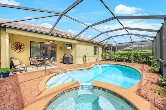 view of pool with a pool with connected hot tub, a patio area, and grilling area