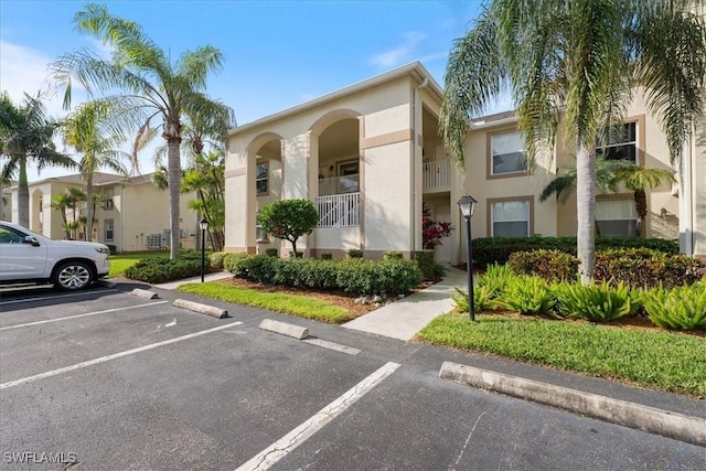 21320 Lancaster Run Unit 1122, Estero, FL 33928 - view of building exterior featuring uncovered parking