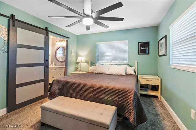 1622 Piney Rd, North Fort Myers, FL 33903 - bedroom with a barn door, carpet floors, ensuite bath, baseboards, and ceiling fan