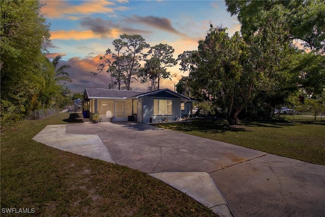 view of front of home with concrete driveway and a front yard