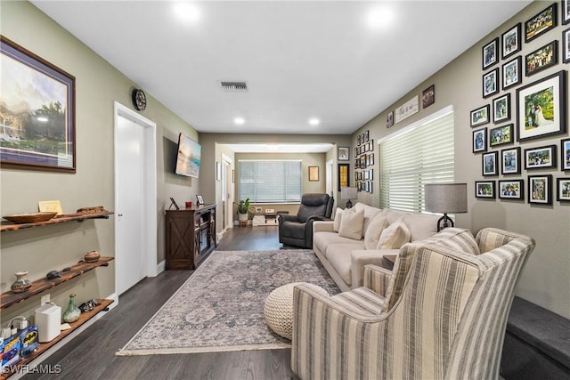 living area with recessed lighting, visible vents, and dark wood-style flooring