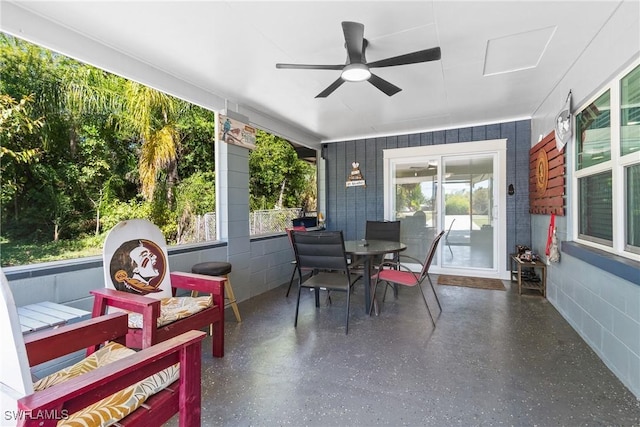 sunroom / solarium featuring a healthy amount of sunlight and a ceiling fan