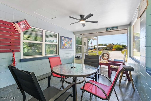 sunroom featuring ceiling fan