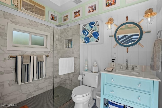 bathroom with toilet, visible vents, vanity, a wall mounted AC, and walk in shower