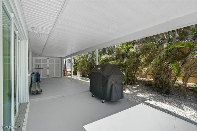 view of patio / terrace with a grill and a carport