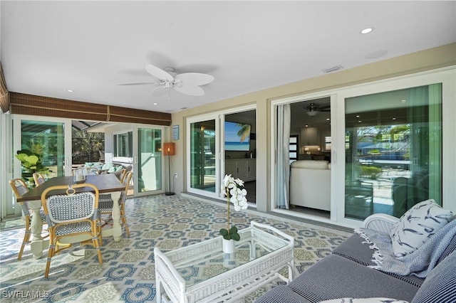 sunroom / solarium featuring ceiling fan and visible vents