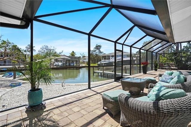 view of patio / terrace featuring glass enclosure, a water view, and outdoor lounge area