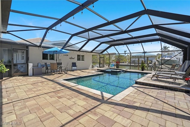 view of pool featuring a patio, a lanai, and a pool with connected hot tub