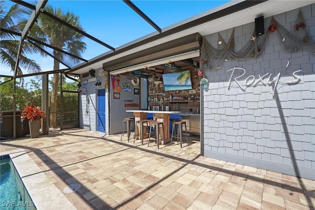 view of patio with glass enclosure