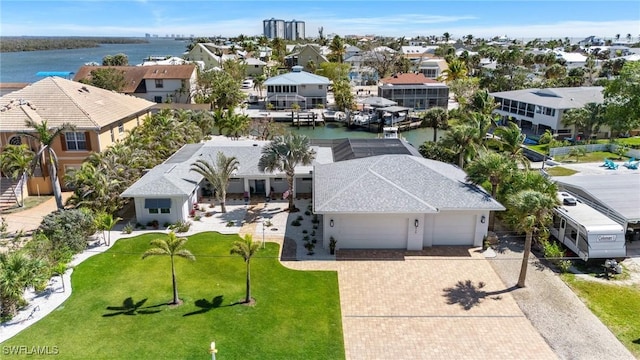 birds eye view of property with a water view and a residential view