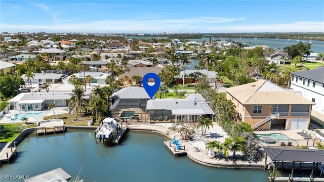 birds eye view of property with a residential view and a water view