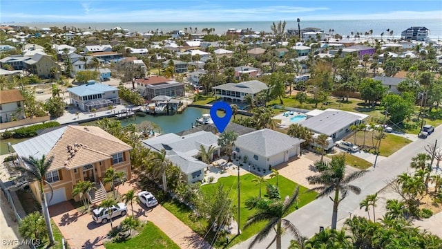 birds eye view of property featuring a water view and a residential view