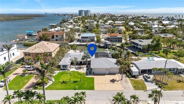 drone / aerial view featuring a water view and a residential view