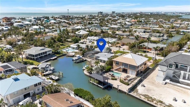 drone / aerial view with a water view and a residential view