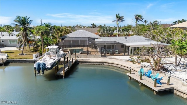 back of property with a swimming pool, a water view, boat lift, and a lanai