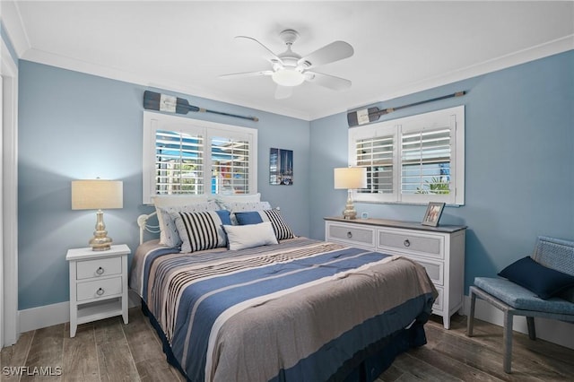 bedroom featuring baseboards, ceiling fan, dark wood finished floors, and crown molding