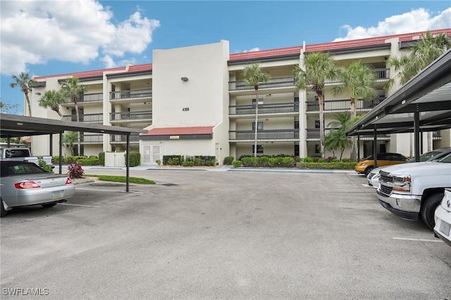 view of building exterior with covered parking