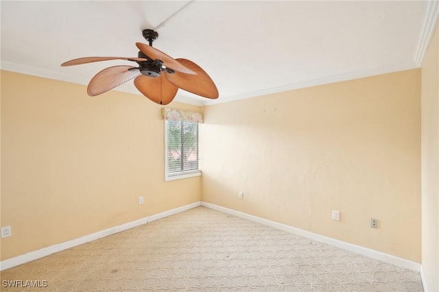 empty room with carpet floors, crown molding, baseboards, and ceiling fan