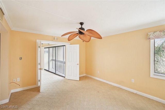 empty room with ceiling fan, baseboards, and crown molding