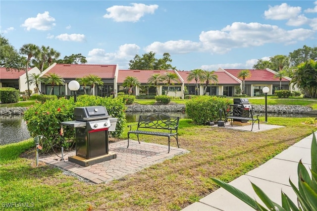 view of property's community with a yard and a water view