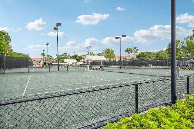 view of tennis court featuring fence