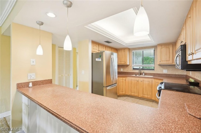 kitchen with stainless steel appliances, a sink, hanging light fixtures, and light brown cabinetry