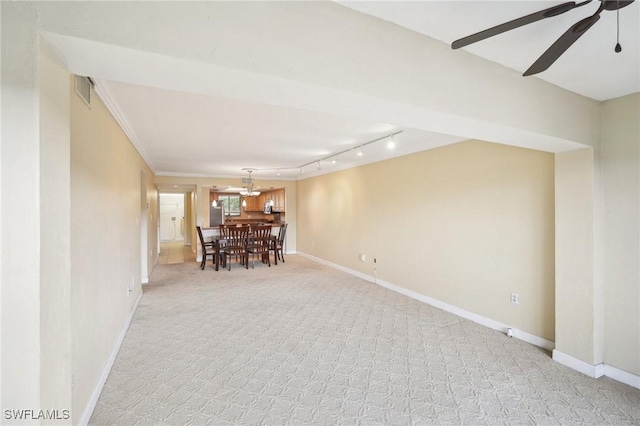 unfurnished dining area with crown molding, visible vents, light carpet, ceiling fan, and baseboards