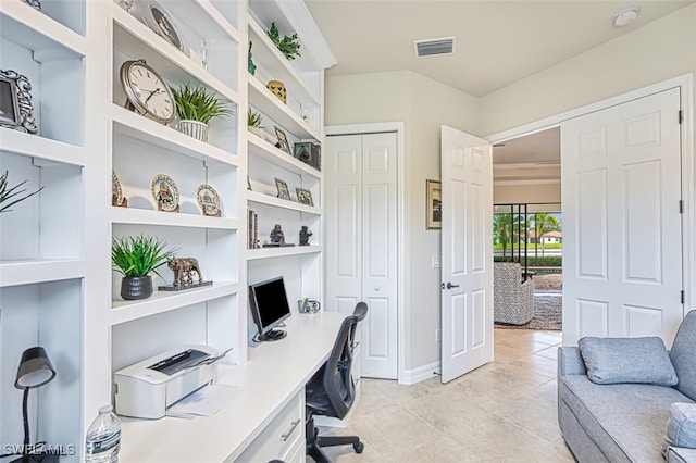 office space with light tile patterned floors, visible vents, and built in shelves