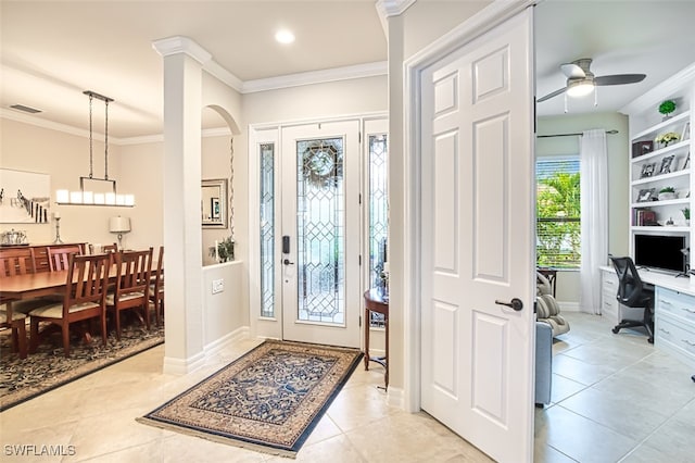 foyer with visible vents, crown molding, light tile patterned floors, baseboards, and ceiling fan