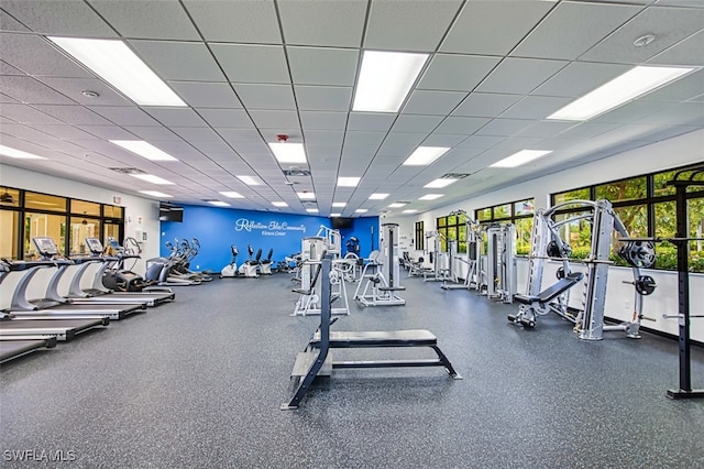 exercise room with visible vents and a paneled ceiling