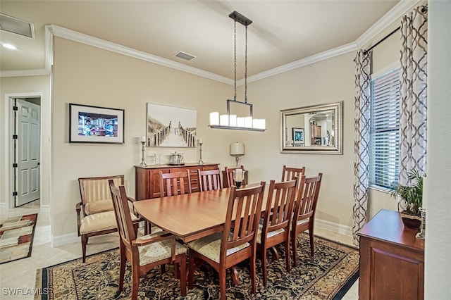 dining room featuring visible vents, baseboards, and ornamental molding