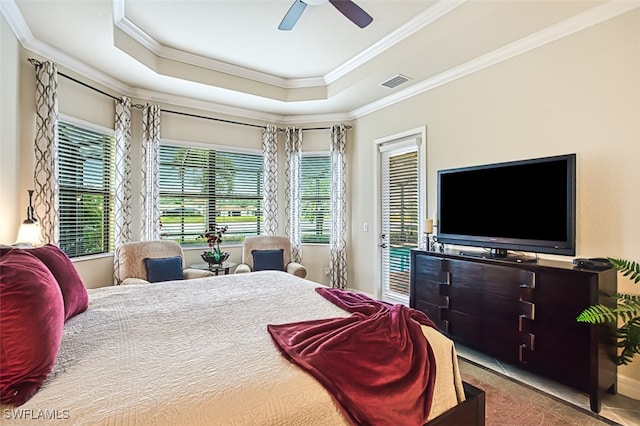 bedroom featuring access to exterior, visible vents, crown molding, and a tray ceiling